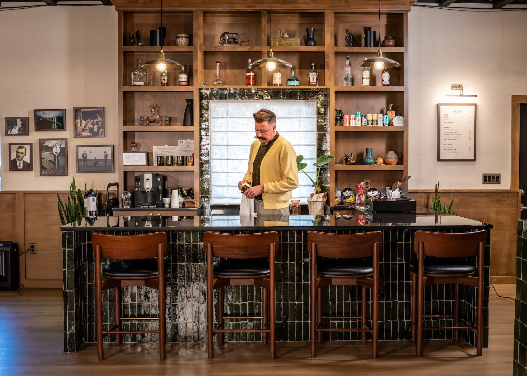 Barber behind the green tile bar at Fairway