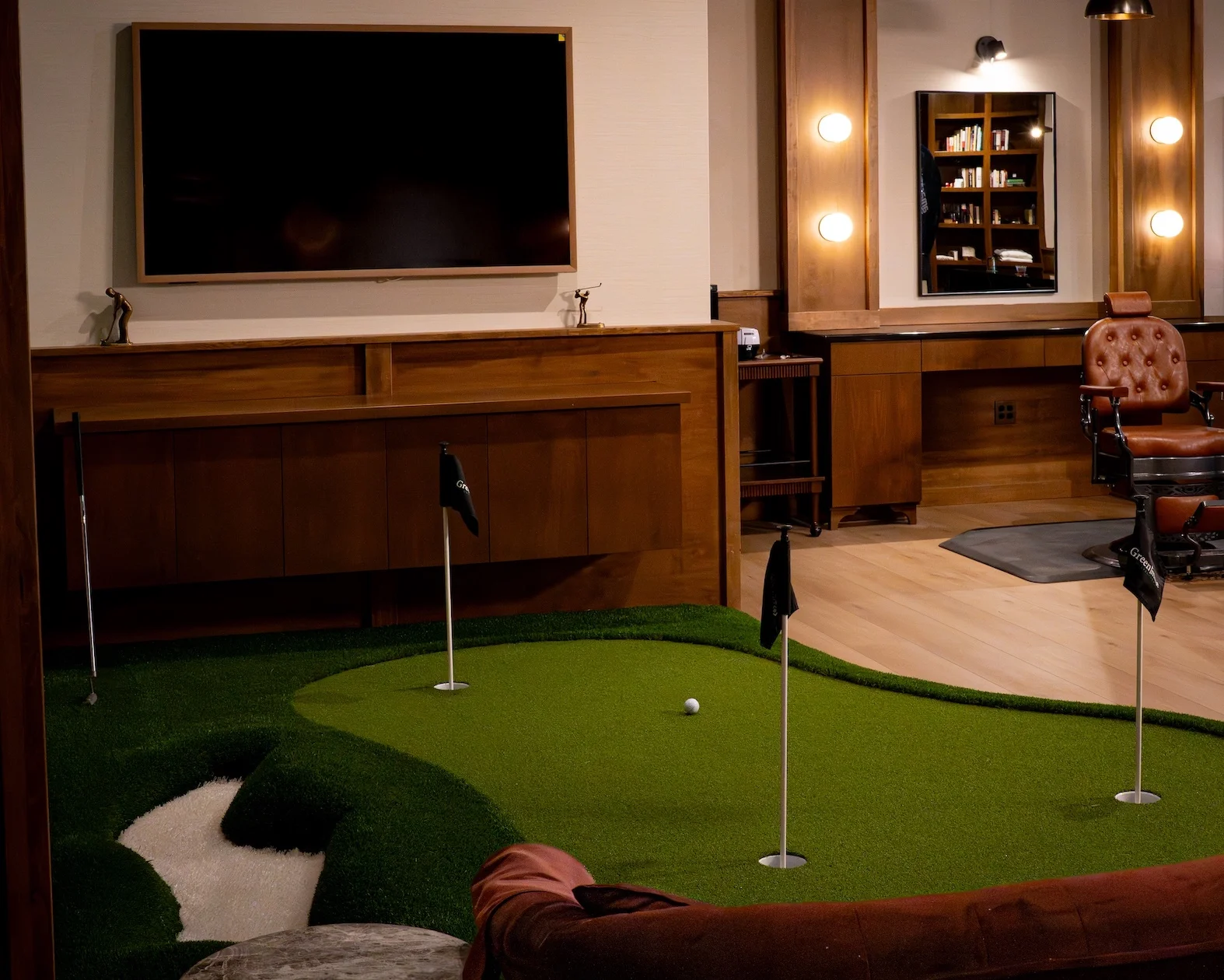 Indoor putting green beside the barber chair
