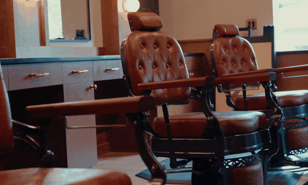 Inside Fairway Barber Club — clients in chairs, barbers at work, lounge seating